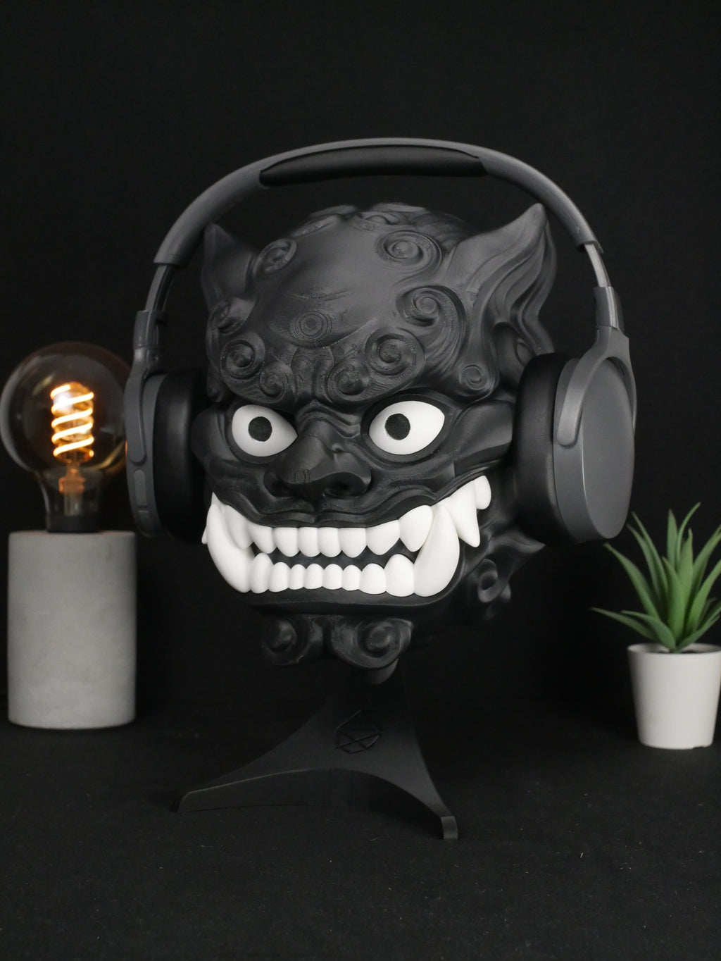 Soporte para auriculares Foo Dog personalizable sujetando cascos grises.